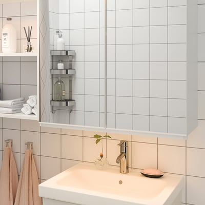 Modern bathroom vanity with led lights, chrome tap, plant vase, soap dish, light tiles.