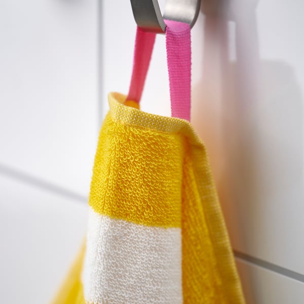 Bright yellow-striped absorbent cotton towel hanging, showcasing its soft and durable design.