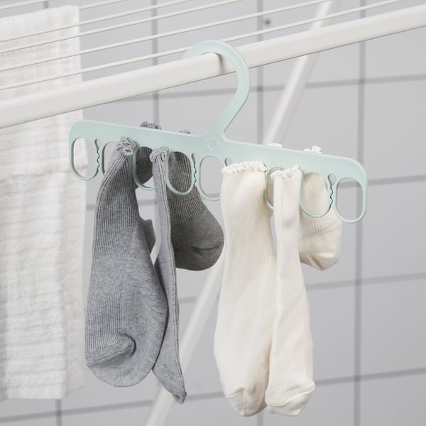 Hanger with multiple loops holds grey and white socks for drying, showing easy organisation.