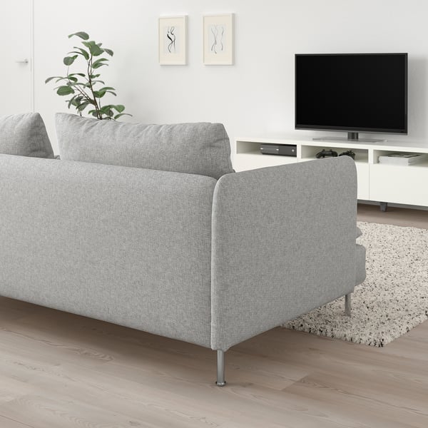 SÖDERHAMN grey sofa with light legs sits low & deep. Modern, clean lines. Smaller than tv & plant.