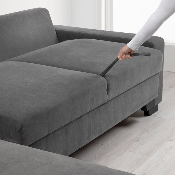 Person opening sofa chaise with storage.