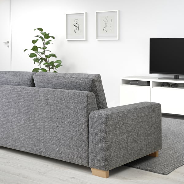 Grey SÖRVALLEN 3-seat sofa in minimalist living room with tv & plant.