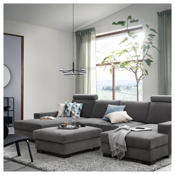Modern living room with grey SÖRVALLEN sofa set, large window, green curtains, and a tall plant.