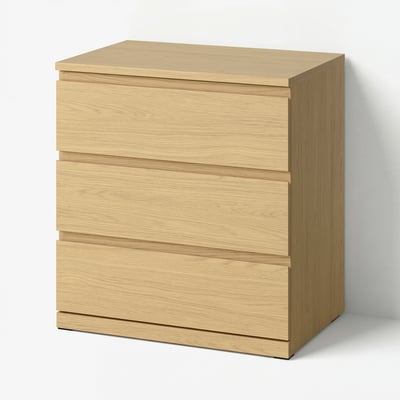 A light brown wooden chest of drawers with three drawers and smooth, horizontally lined handles.