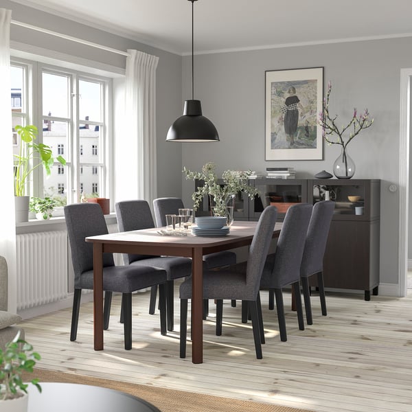 Modern dining room with STRANDTORP table & chairs. Light wood floor. Grey chairs, black pendant light. Large window, grey walls.