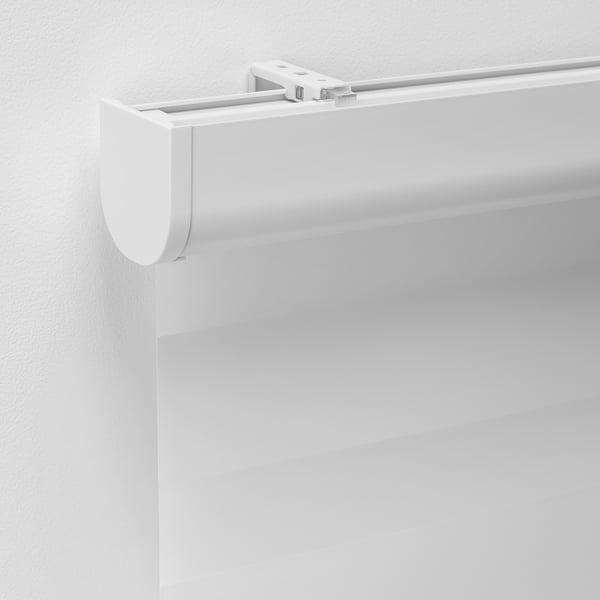 Close-up of a modern white double roller blind, showing sleek design and quality materials.