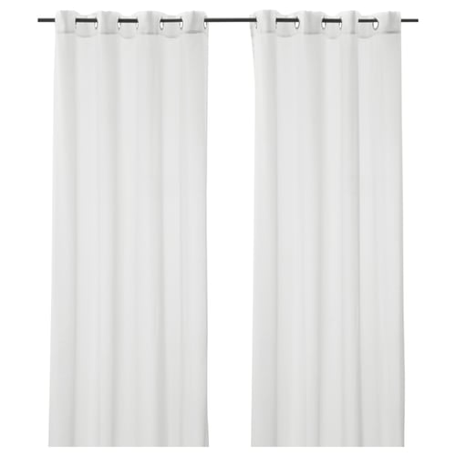 Two white, sheer curtains hang side by side, each with metal grommets at the top, providing privacy while allowing light through.