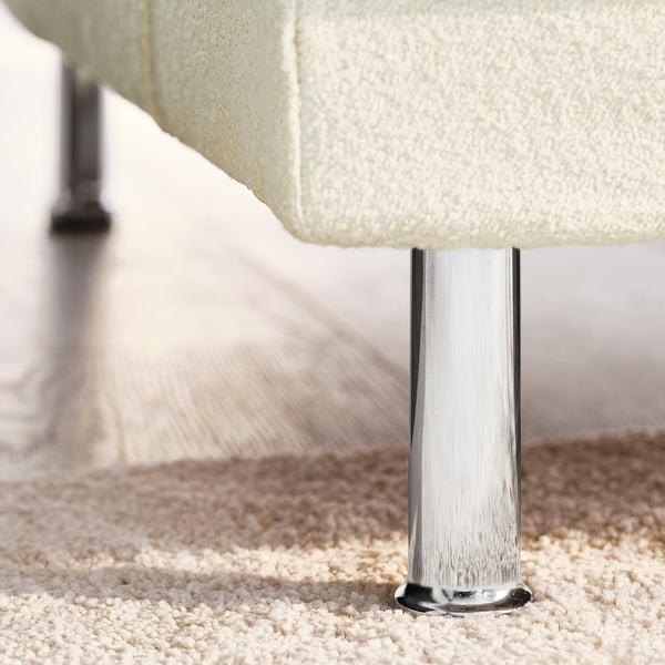 A plush white sofa with shiny chrome legs, exuding comfort and elegance.
