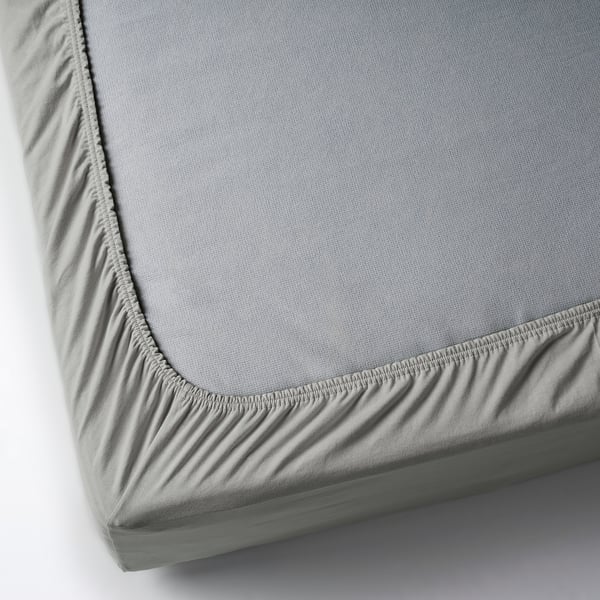 A grey cotton mattress topper with jersey fitted sheet, elastic edges for corner fit.