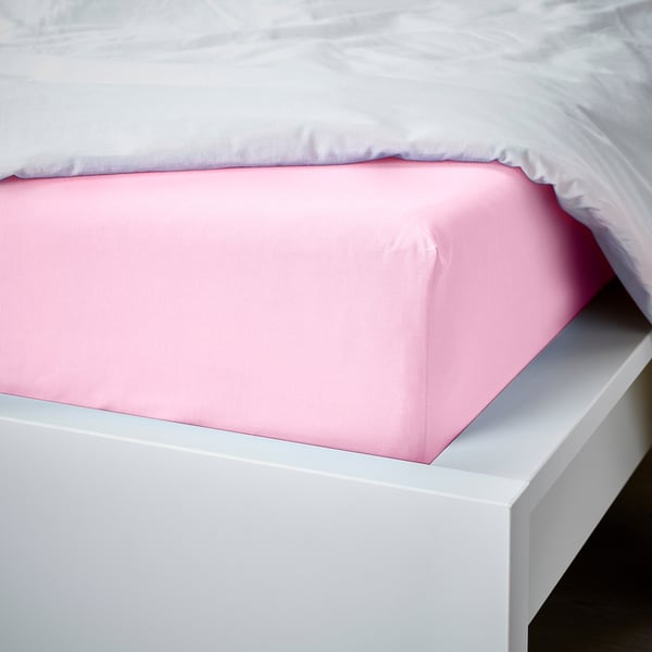 Pink fitted sheet on white bed, showcasing snug fit and clean look.
