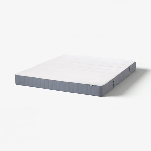 A rectangular grey and white mattress with true blue accents, featuring bonnell springs and foam for medium-firm support.