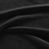 Image shows a close-up of soft, textured black velvet fabric with subtle light reflection, highlighting its quality and texture.