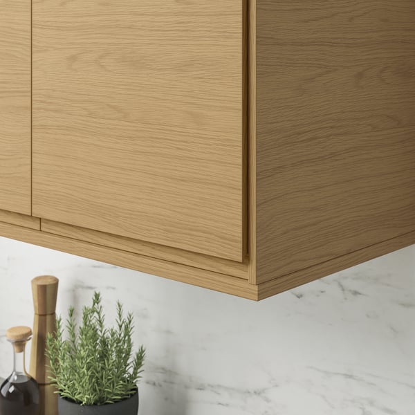 Modern oak kitchen cabinets with sleek edges and hidden light cords.