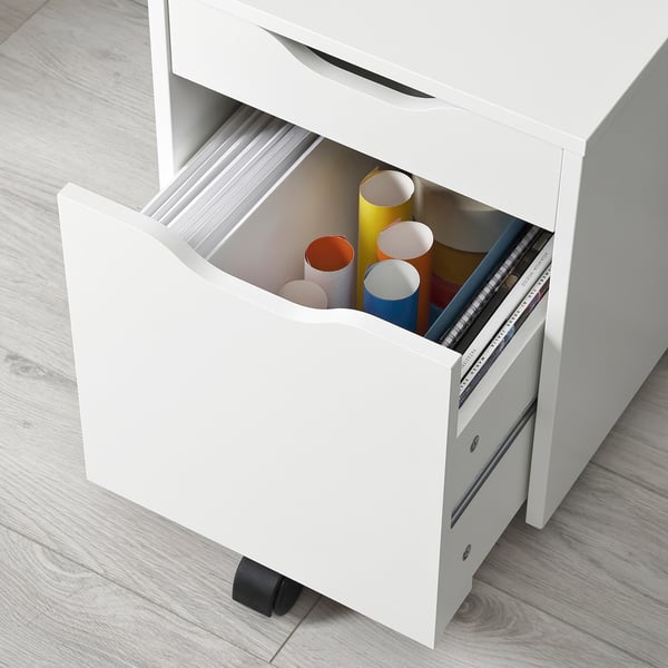White rolling storage unit with open drawer showing colourful paper tubes.
