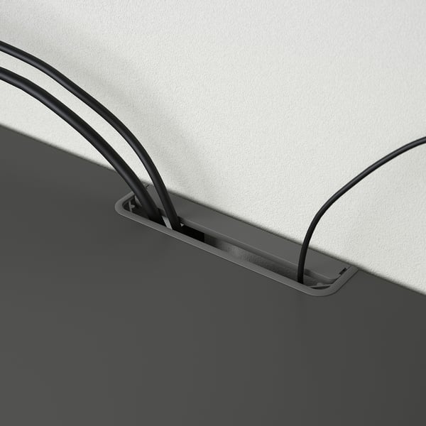 Black tv bench with cord management; adjustable feet; outlets for cable organisation.