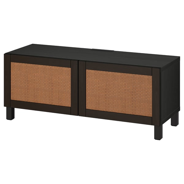 A black ikea BESTÅ tv bench with woven panels. It has two doors and offers hidden storage for electronics.