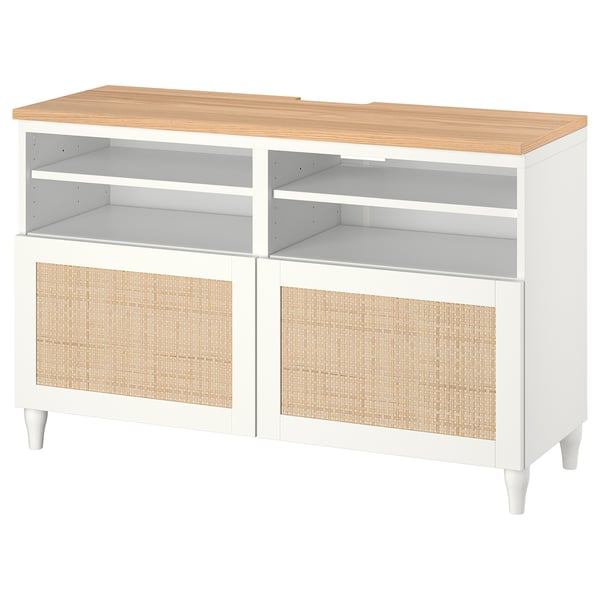 Modern white tv console with wicker doors and wooden top.