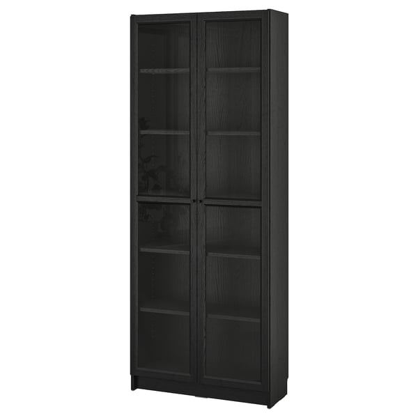 A BILLY bookcase in dark brown. It has glass doors and adjustable shelves, suitable for displaying items while protecting them from dust.