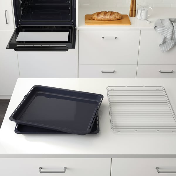 Modern kitchen with BRÄNDBO oven displaying baking trays and a loaf on the counter.