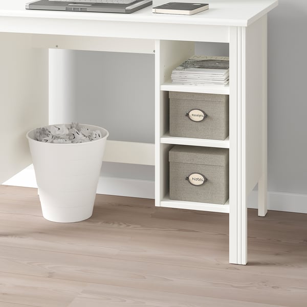 White desk with adjustable shelves holding boxes and a bin full of paper.
