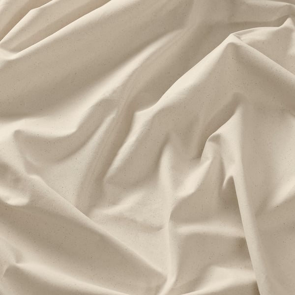 Cream-colored cotton fabric, smooth and slightly textured, draped softly.