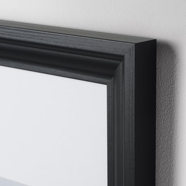 Black frame on white wall, high-quality with plastic protection.