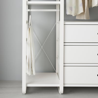 White ELVARLI storage unit with cross-brace for stability, hanging shirts.