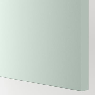 A close-up of a pale grey-green cabinet front, smooth and modern, reflecting quality and durability.