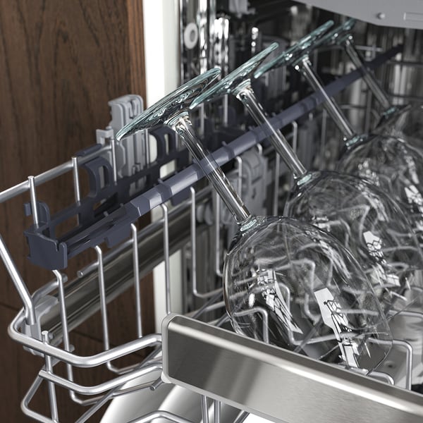Open dishwasher with wineglasses in upper rack, showcasing its spacious 3-level design and cutlery compartment.