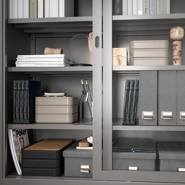 Organised shelves with HARVMATTA boxes storing paper and desk accessories.