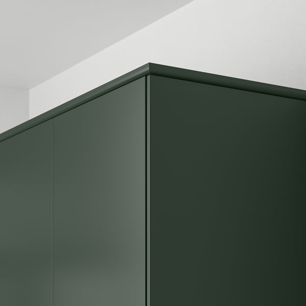 Dark green kitchen cabinet panels with smooth surface and straight lines.