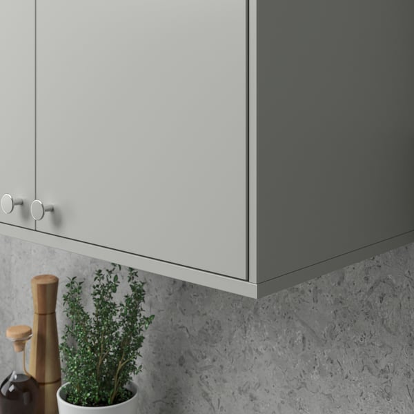 Modern kitchen with grey cabinets and wooden plant.