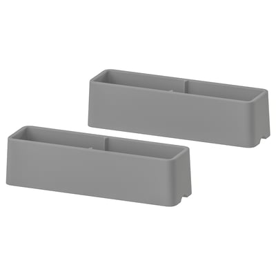 Two grey rectangular plastic furniture guards.