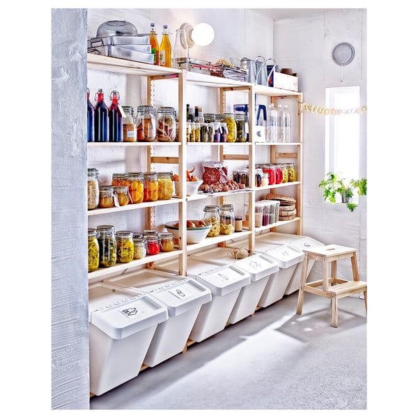 IVAR shelving units in white pine, holding jars and containers, with a minimalist design.