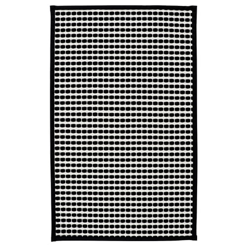 KALLGATE bath mat, black/white dot pattern, rectangular, polyester with latex backing.