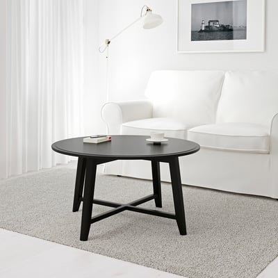 Modern living room with KRAGSTA table and white armchair.