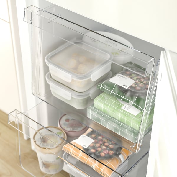 Open refrigerator with three shelves, two freezer drawers full of various food containers.
