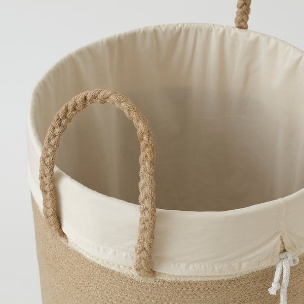 Natural woven laundry basket with sturdy handles, inner cotton bag, high-quality jute & cotton blend, rustic yet durable design.