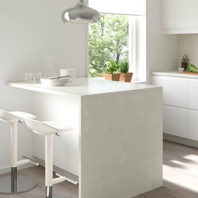 Modern kitchen with LOCKEBO glass countertop, eco-friendly, island setup, two stools, lamp, and large window.