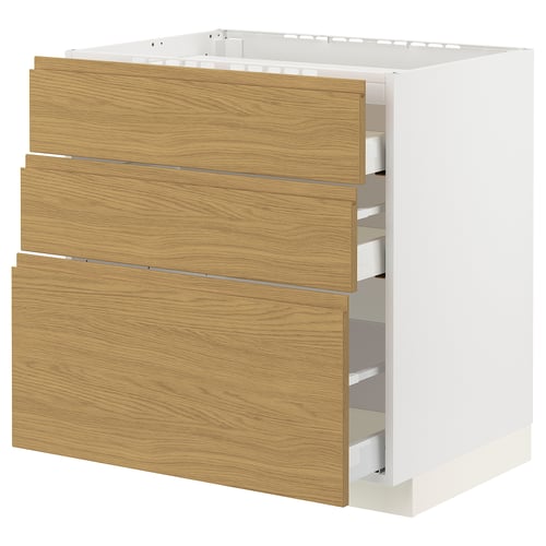 Modern white cabinet with oak drawers. Three drawers, minimalist handles, white frame.