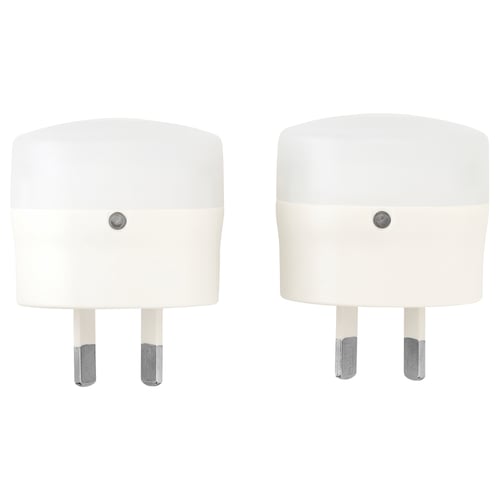 Two white, cylindrical automatic nightlights with silver accents, designed by MÖRKRÄDD.