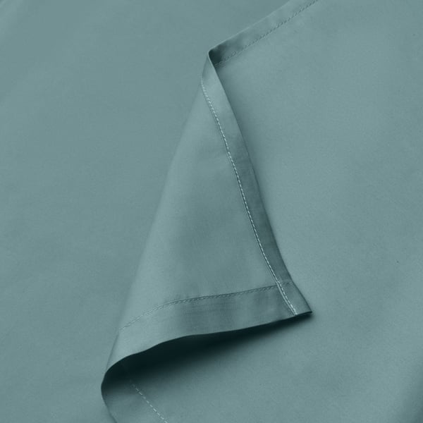 Close-up of smooth blue-green bed sheet with pleated edge, fine weave.