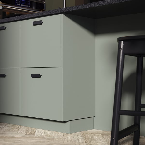 Modern kitchen with grey-green NICKEBO cabinets, black handles, and a black stool.