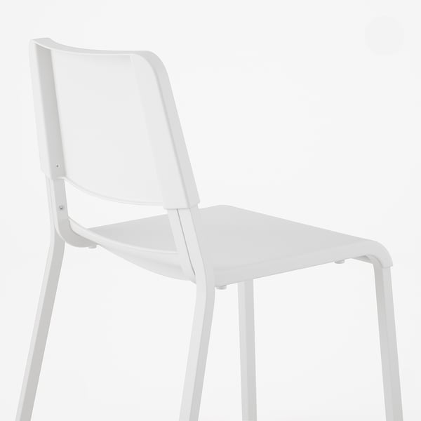 Modern white chair with curved back, thin legs, minimalist design.
