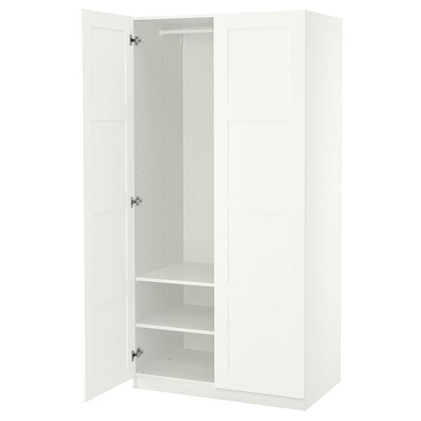 An open white PAX wardrobe with shelves inside. The design is minimalist and modern.