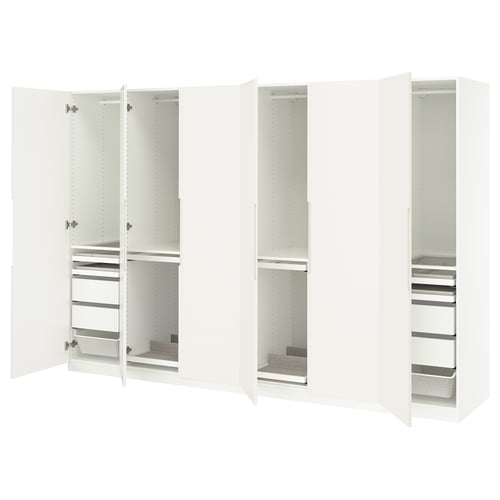 White PAX wardrobes: tall, sleek, with open doors revealing shelves and drawers for organised storage.