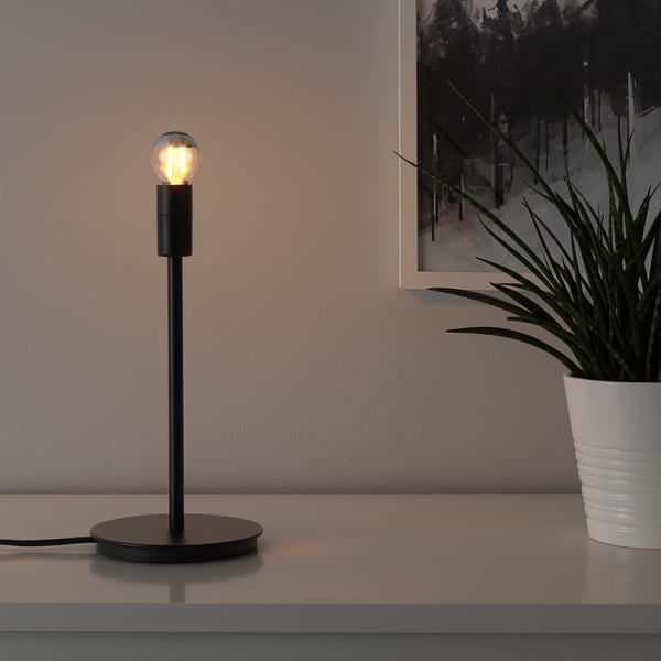 Lit lamp, white plant. Or modern lamp with lit bulb.