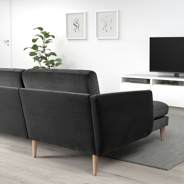 Modern living room with grey SMEDSTORP sofa featuring soft shapes, wooden legs, and high-resilience foam cushions. Tv and plant nearby.