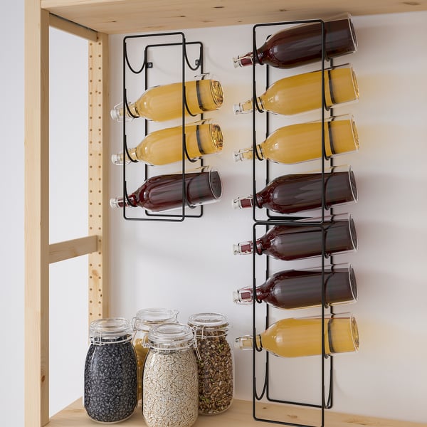 Bottles stored neatly in wall-mounted metal racks. Four bottles per rack, organised horizontally.
