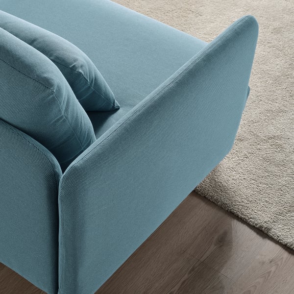 Light blue SÖDERHAMN sofa with plush cushions on a rug, emphasising comfort and modern style.
